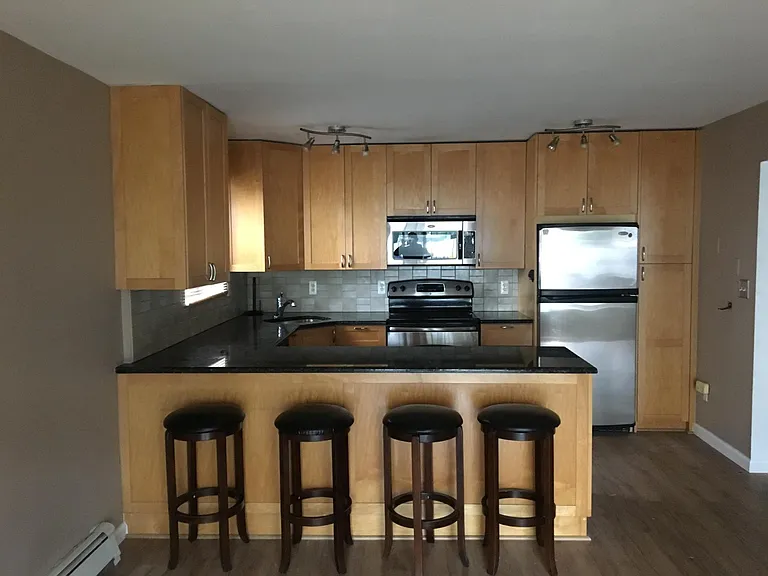 kitchen with stainless steel appliances and dishwasher and large counter for dining and entertaining