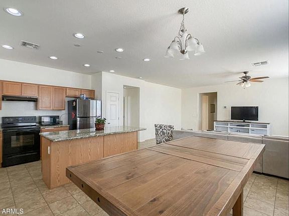 Main living space before new light gray paint throughout the whole house. Kitchen, living room and dining room all open floor plan.