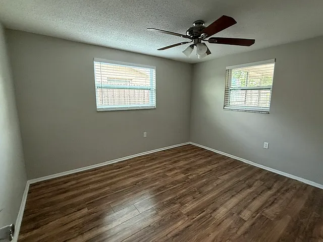 Left back bedroom with new windows and faux wood mini blinds