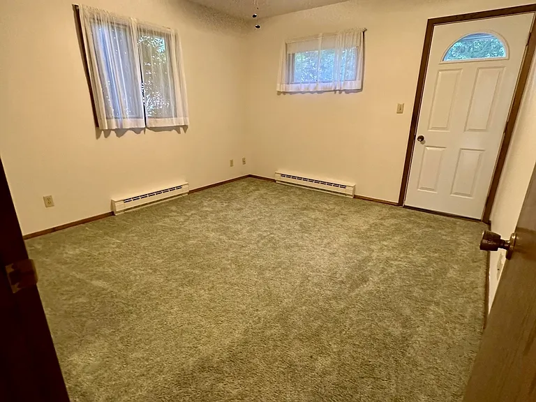 Comfortable bedroom with neutral paint and abundant natural light. The room provides flexibility for use as a guest bedroom, children's room, or home office. Clean and well-maintained, the space offers a practical layout and move-in-ready condition.