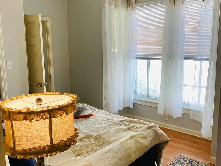 The First bedroom's Southeast facing Bay windows and overhead light keep the space bright!