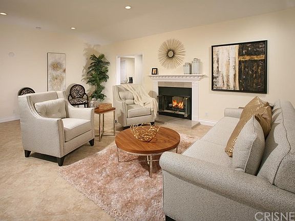 The spacious living room is bathed in natural light and is further accented by its smooth ceiling wi