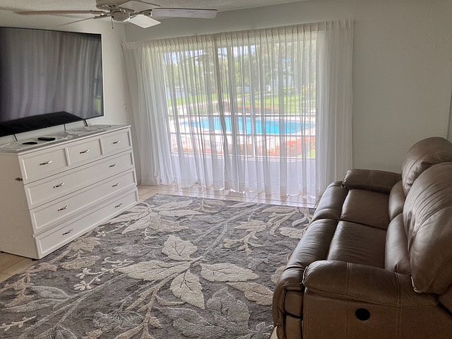 Bright, inviting living room with sliding doors overlooking the pool.