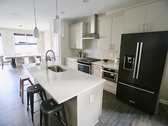 Open designed kitchen with Black stainless steel fridge