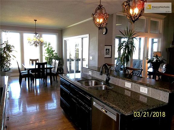 Kitchen Island with Upgraded Sink and Faucet and Granite Counter Tops and Bar.