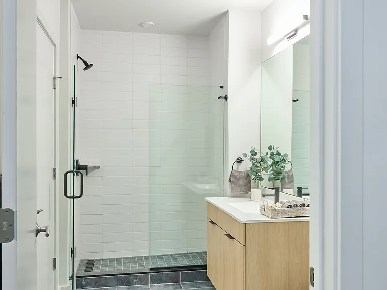 Expansive bathrooms with glass shower doors and high-end finishes