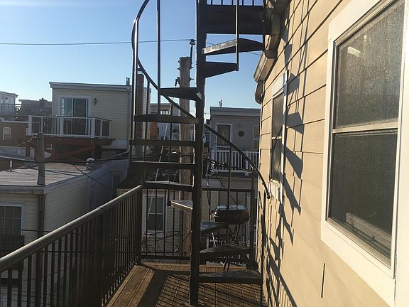 Back deck with staircase to rooftop