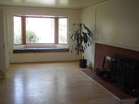 Large living room with bay window and fireplace