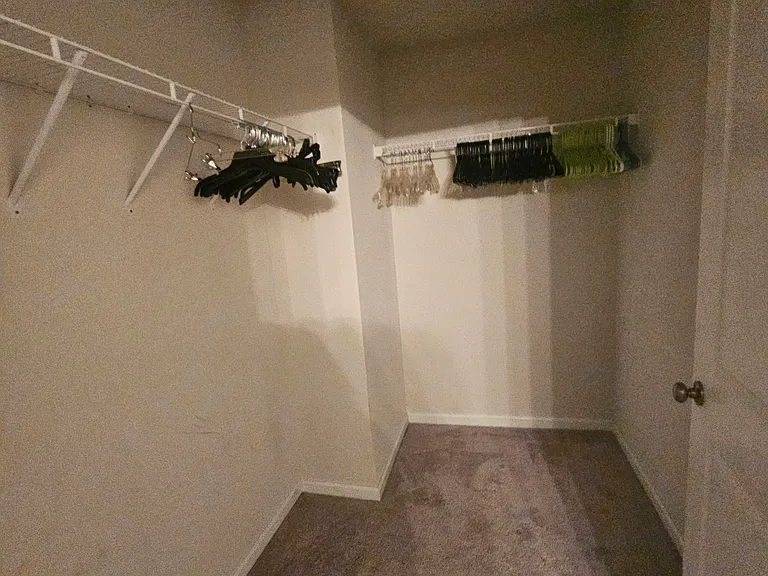 Walk in master closet. I don't know why I didn't take down the hangers before I took this. I am obviously not a great photographer, lol.