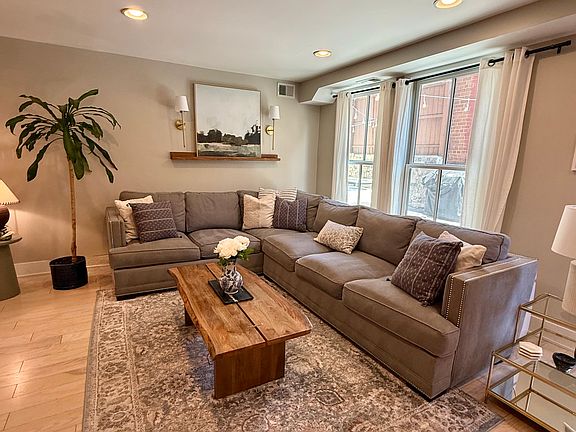 Living room - Floor to ceiling windows overlook private outdoor space, creating indoor/outdoor living concept