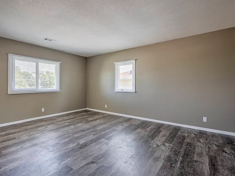 Grey walls in a living room with white trim at Ashland Park Apartments.