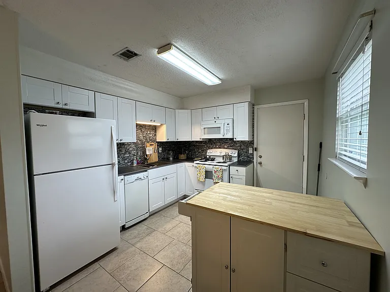 Kitchen with island on rollers.