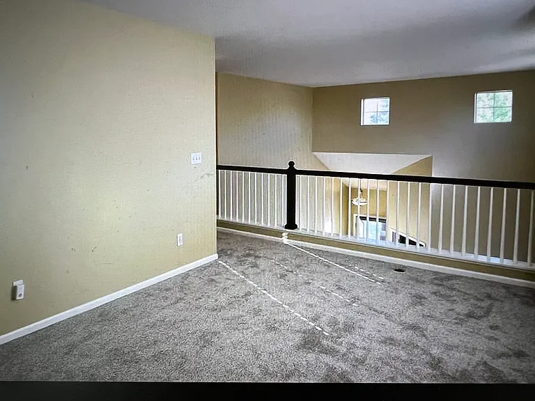 Second-floor loft area, mail entry door in the distance.