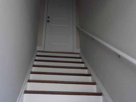Stairs leading to private locked upper level apartment