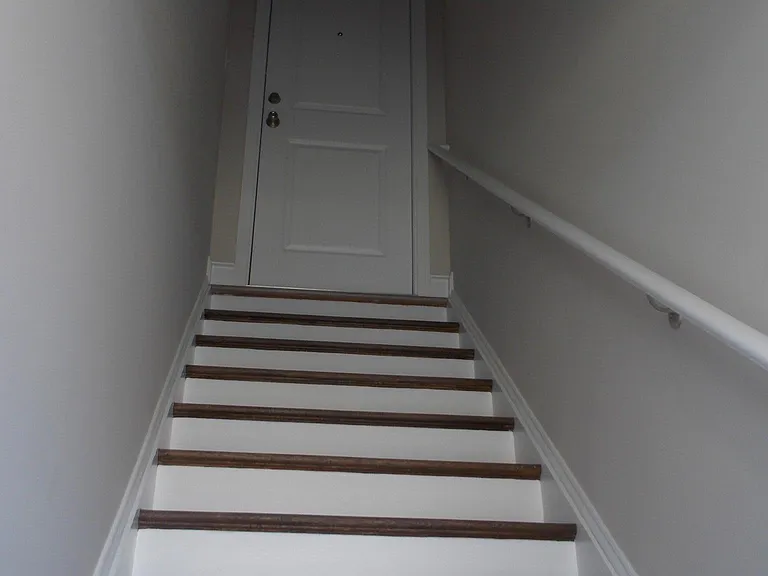 Stairs leading to private locked upper level apartment