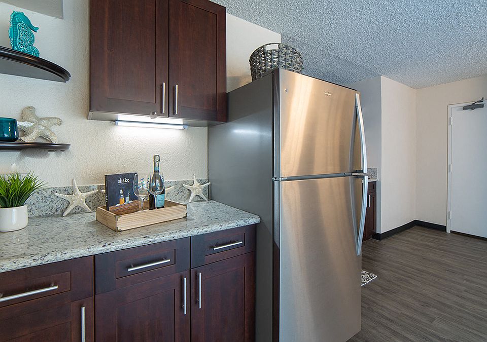 Waikiki Walina Apartments entry way and kitchen area with appliances, cabinets, and counters