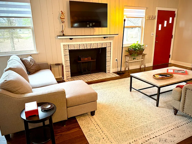 Living room with smart tv, decorative fireplace, complete with a record player & collection of vinyls!