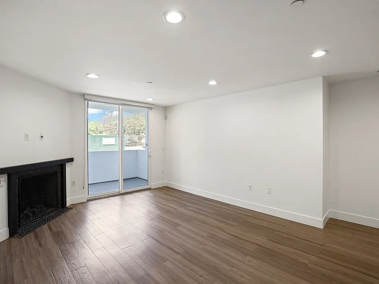 Living Room with Electric Fireplace, Recessed Lighting, Vinyl Flooring, and Patio