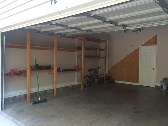 Oversized 2 car garage with shelving & storage room