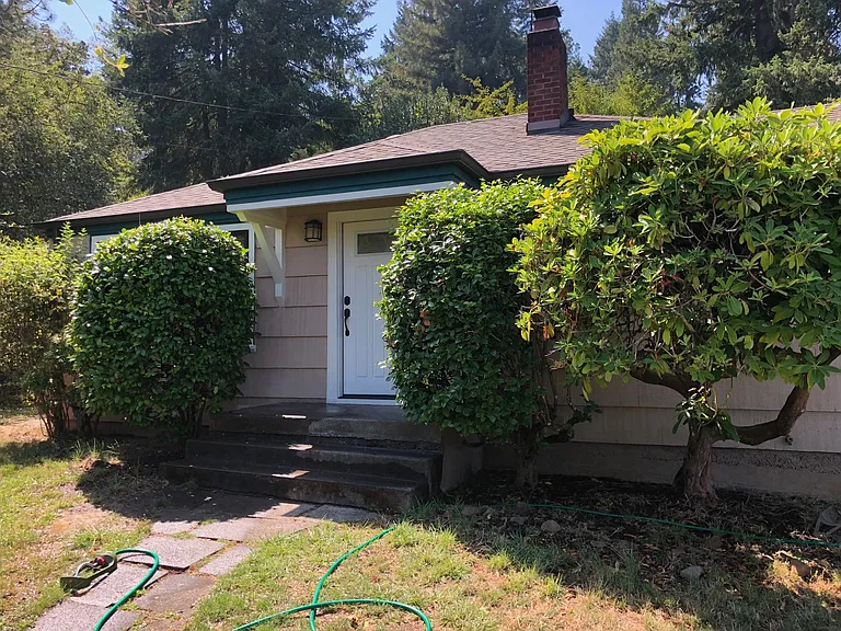 Front: Landscaping includes rhododendrons, camelia, mock orang