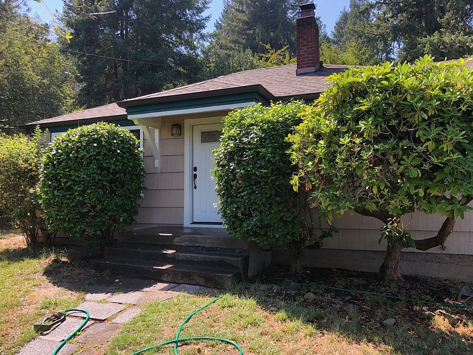 Front: Landscaping includes rhododendrons, camelia, mock orang
