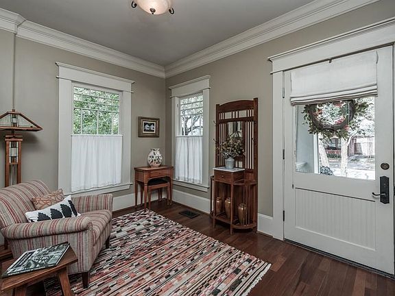Stepping through the original front door you find yourself in the spacious foyer. Deep crown moldings, mahogany hardwood floors and brick patterned windows set the tone for the rest of the home.