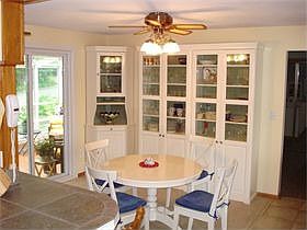Generous informal eating area has room for cabinets and walkouts out to the sunporch. The wallpaper 