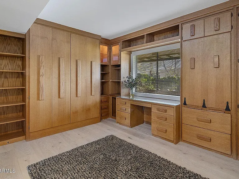 Built-in Murphy bed tucks away neatly, allowing the room to serve as a spacious, dedicated home office.