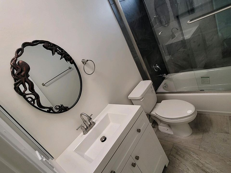 completely brand new bathroom with tile shower, glass doors etc.