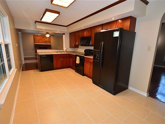 Spacious kitchen with area for kitchen table. Tile flooring throughout kitchen.