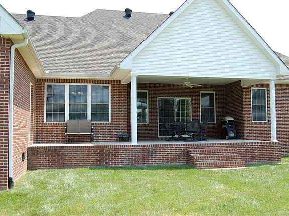 "The deep porch and ceiling fan offer shade and a cooling breeze for relaxation"