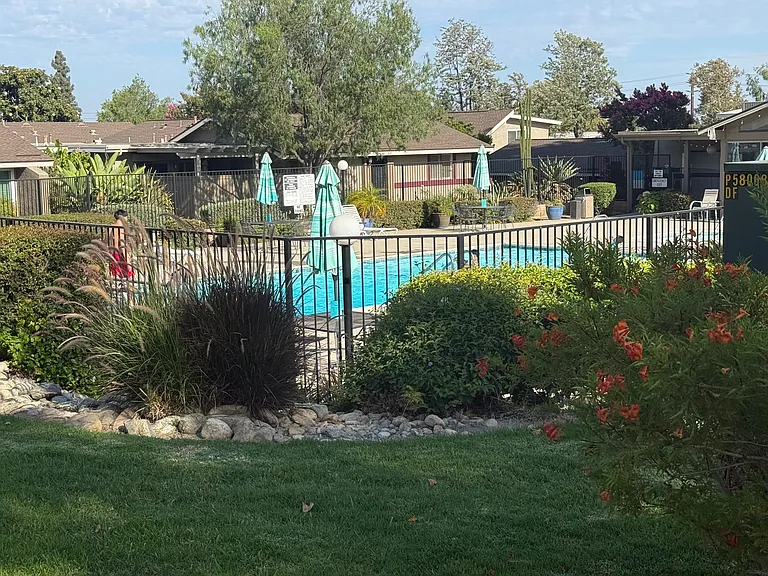 Residents of Upland Knolls enjoy beautifully maintained grounds with resort-style amenities, including a private community pool and spa, clubhouse, rock-lined stream beds, a tranquil pond, scenic walking paths, and expansive open green spaces.