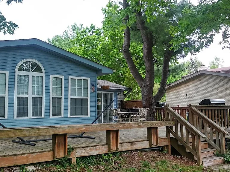 A generously sized patio creates the perfect outdoor retreat, accommodating a hammock, grill, and multiple entertainment areas for gatherings and relaxation.
