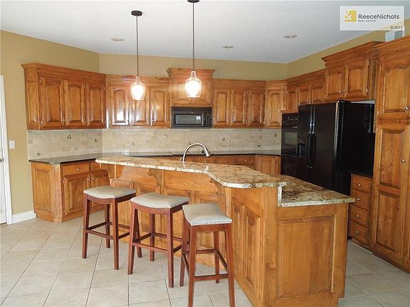 This is a WOW kitchen. Beautiful large bar area with light colored granite, touch faucet and newer dishwasher.