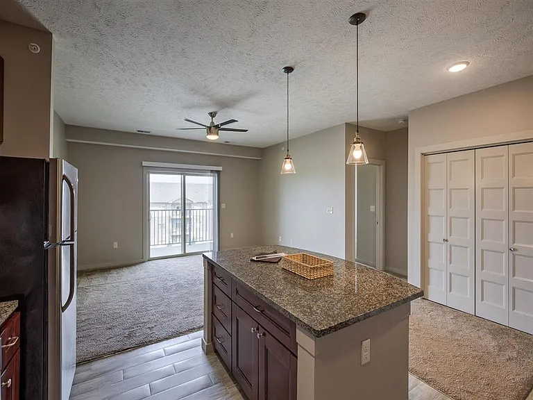 Kitchen island, living room, bedroom entrance.