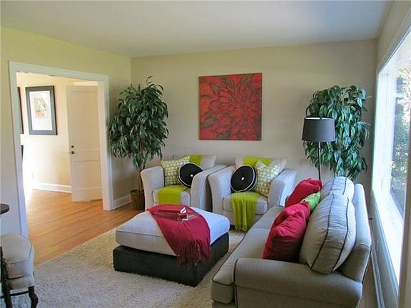 Beautiful, Bright Living room with vintage hardwood flooring and a flower bed area in front of large picture window