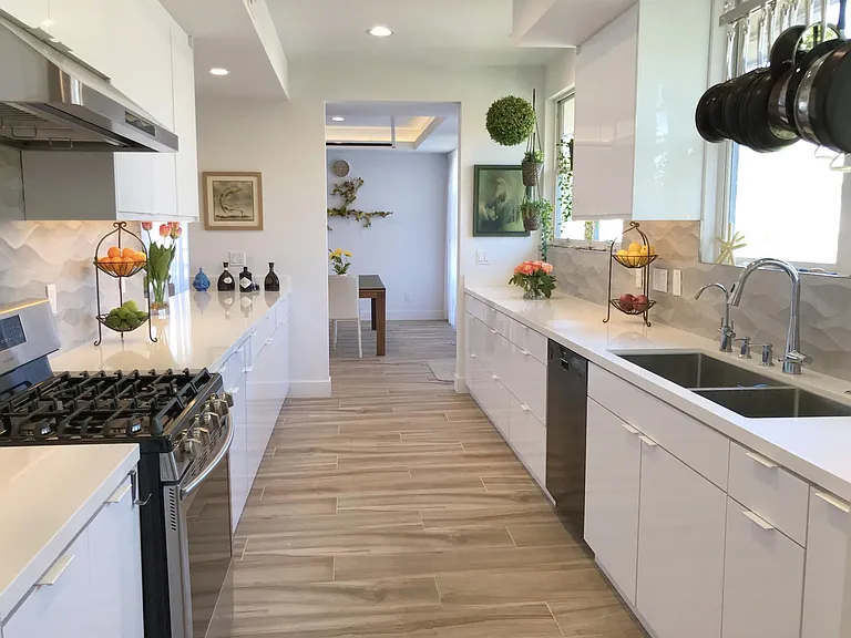 Chef's kitchen features oversized double sink with enough space to store dirty pots and pans (with long handles) INSIDE sink to keep counters clutter-free. Custom designed TALL upper cabinets allow space for Vitamix Blender, Juicers, and other tall applia