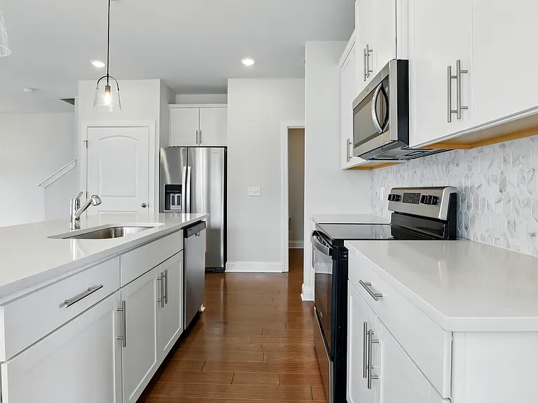 Kitchen - Includes new Whirlpool appliances: refrigerator, microwave, oven, and dishwasher. Also features a walk-in pantry for added storage.