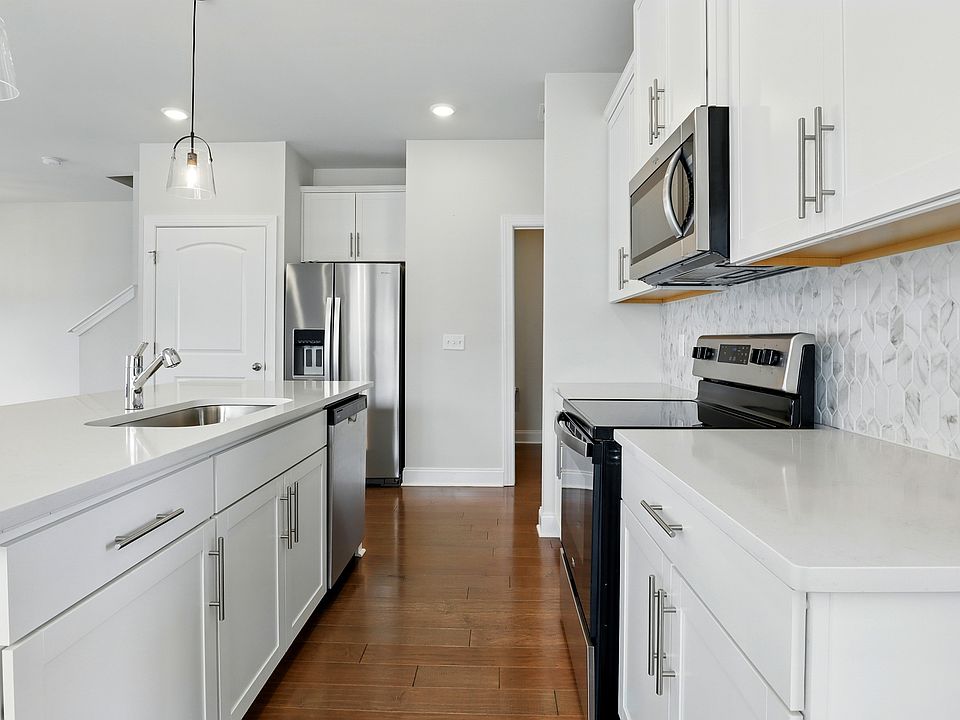 Kitchen - Includes new Whirlpool appliances: refrigerator, microwave, oven, and dishwasher. Also features a walk-in pantry for added storage.
