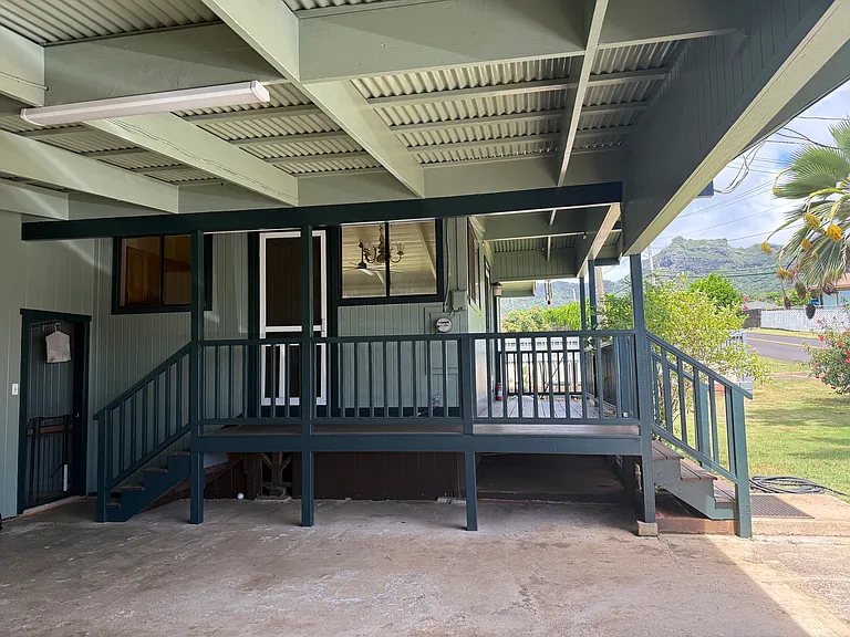 Entrance into house from carport. Additional entrance from front yard.