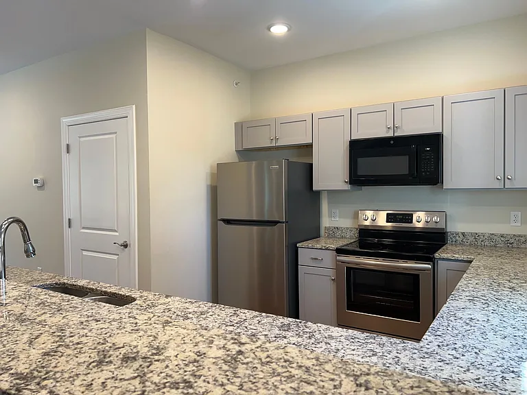 The large kitchen has long granite countertops, a pantry and abundant cabinetry along with a full suite of appliances.