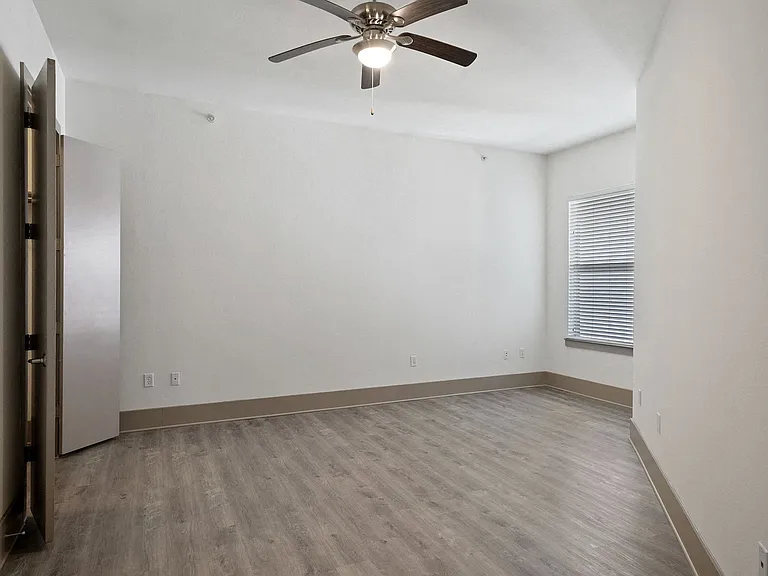 Wood-style flooring extends to the bedroom