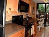 Modern eat-in kitchen with pull out shelves and sleek new black appliances