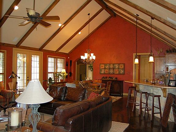 Family room that opens to Kitchen with custom beams and high ceilings.