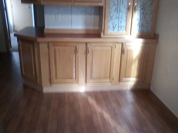 Larger view of built in china area and nice kitchen floor.