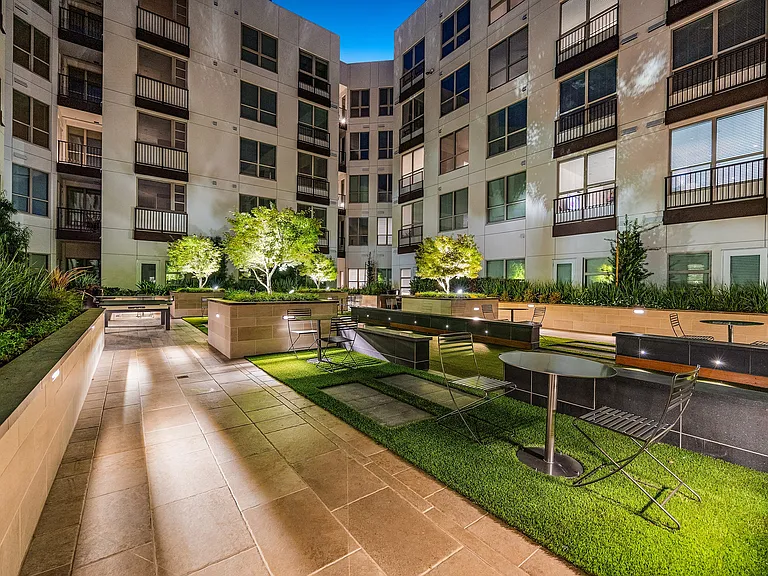 Courtyard with greenery, seating, and modern outdoor design