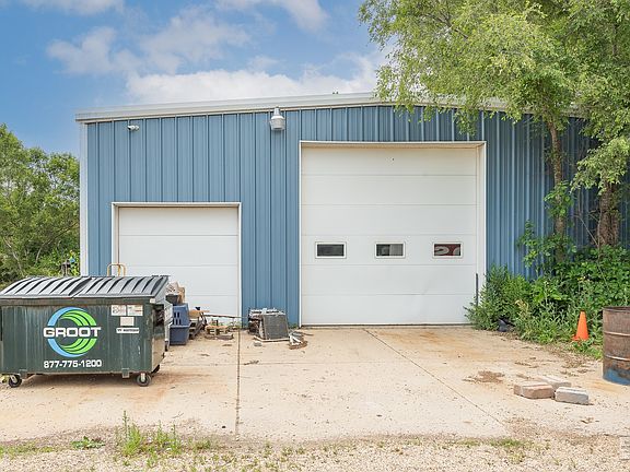 This MASSIVE garage is (40'x60') with heat and electricity! 7-1/2" thick concrete floors and 7'+ doo