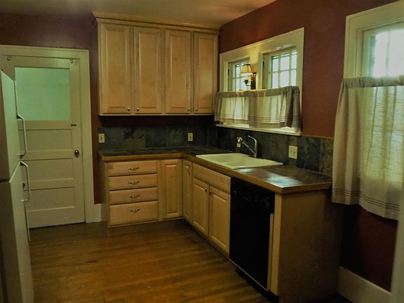 Remodeled kitchen includes maple cabinets, gas range, d/w.