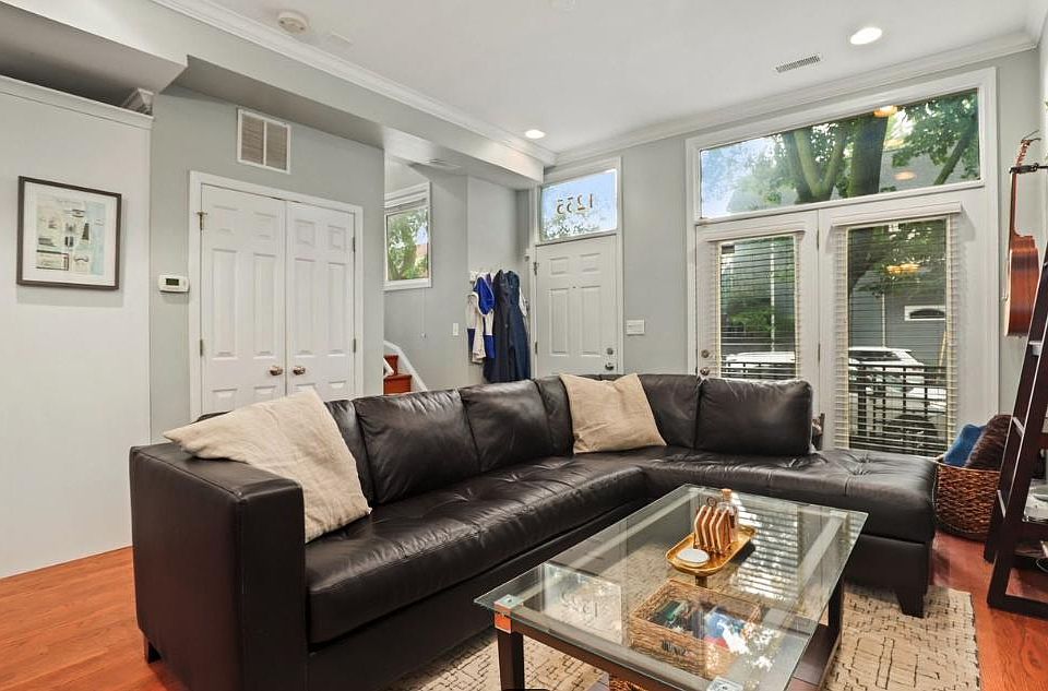 Main living area with gas fireplace. First floor with picture windows and lots of natural light.