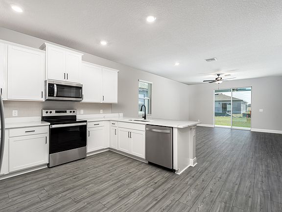 This kitchen overlooks the spacious living area.